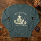 Slow Mornings Snail Sweatshirt in Blue Spruce, a sleepy snail carrying a coffee cup on its shell
