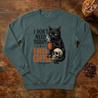 I Don't Need Therapy Cat Sweatshirt in Blue Spruce, a black cat holding a coffee mug and sitting on a skull