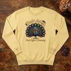 Extra Always Peacock Sweatshirt in Butter, a colorful peacock with coffee