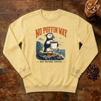 No Puffin Way Sweatshirt in Butter, a puffin holding a cup of coffee by the coast