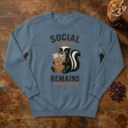 Social Distance Remains Skunk Sweatshirt in Denim, a retro skunk sipping iced coffee