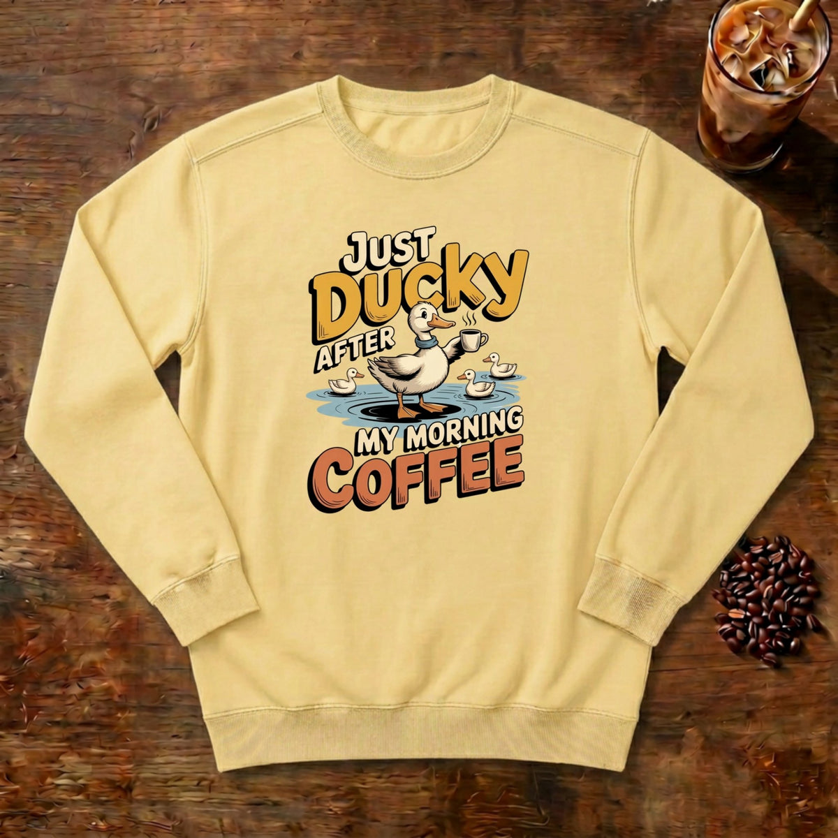 Just Ducky After My Morning Coffee Sweatshirt in Butter, a sleepy duck holding its coffee