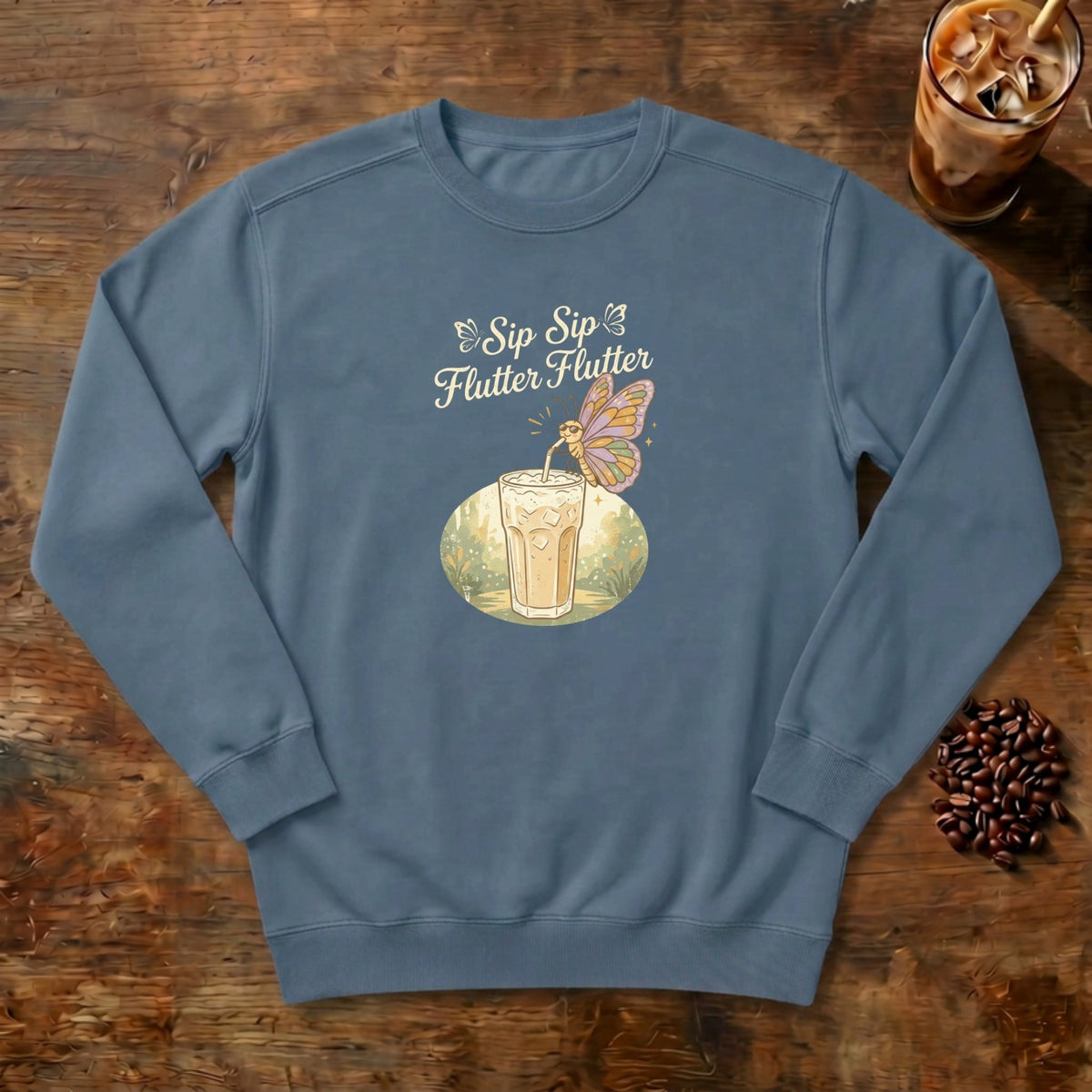 Sip Sip Flutter Flutter Butterfly Sweatshirt in Denim, a monarch butterfly hovering over an iced coffee