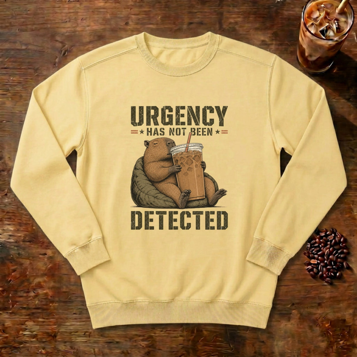 Urgency Not Detected Capybara Sweatshirt in Butter, a relaxed capybara with its coffee