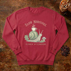 Slow Mornings Snail Sweatshirt in Crimson, a sleepy snail carrying a coffee cup on its shell