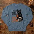 I Don't Need Therapy Cat Sweatshirt in Denim, a black cat holding a coffee mug and sitting on a skull