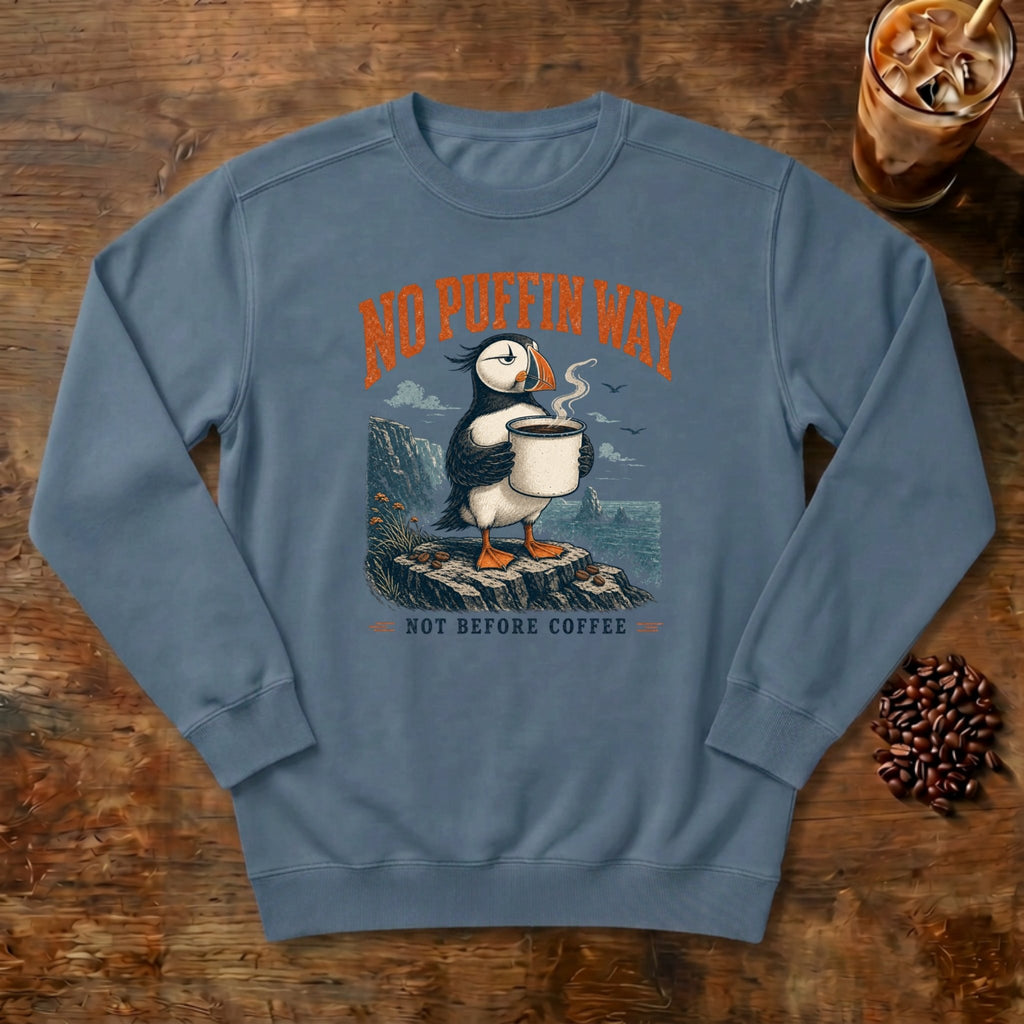 No Puffin Way Sweatshirt in Denim, a puffin holding a cup of coffee by the coast