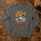 Just Ducky After My Morning Coffee Sweatshirt in Pepper, a sleepy duck holding its coffee