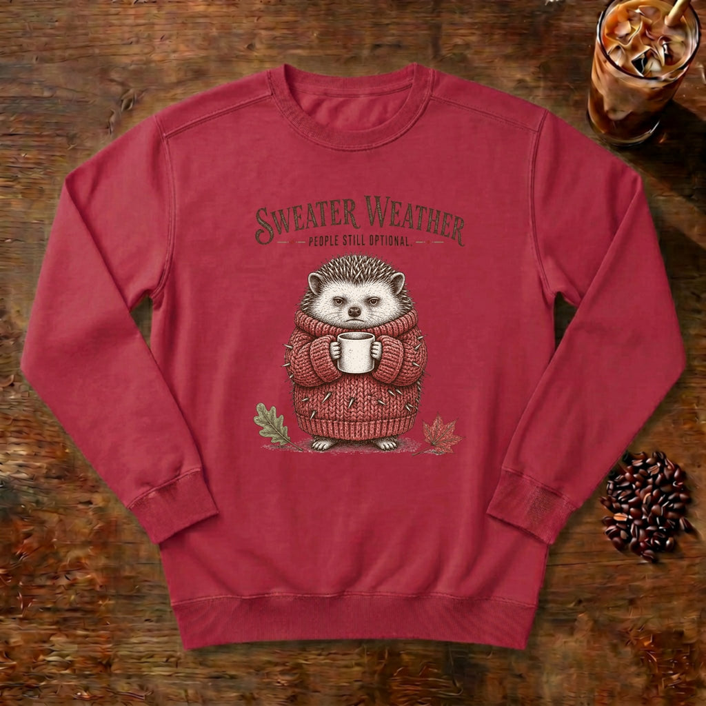 Sweater Weather Hedgehog Sweatshirt in Crimson, a hedgehog in a knit sweater holding a mug