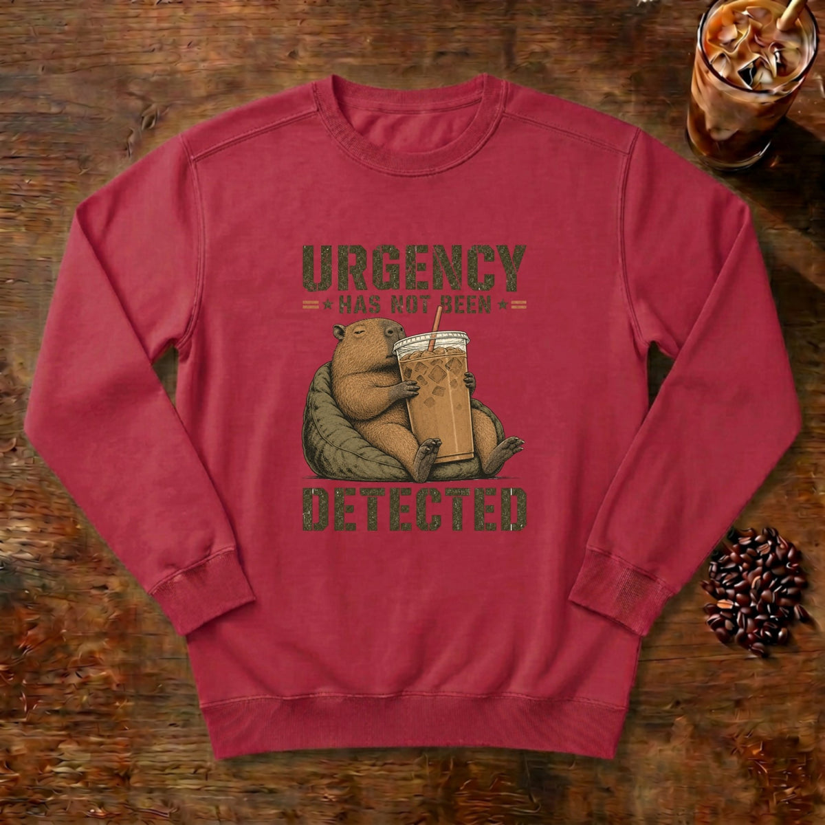 Urgency Not Detected Capybara Sweatshirt in Crimson, a relaxed capybara with its coffee