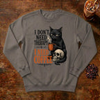 I Don't Need Therapy Cat Sweatshirt in Grey, a black cat holding a coffee mug and sitting on a skull