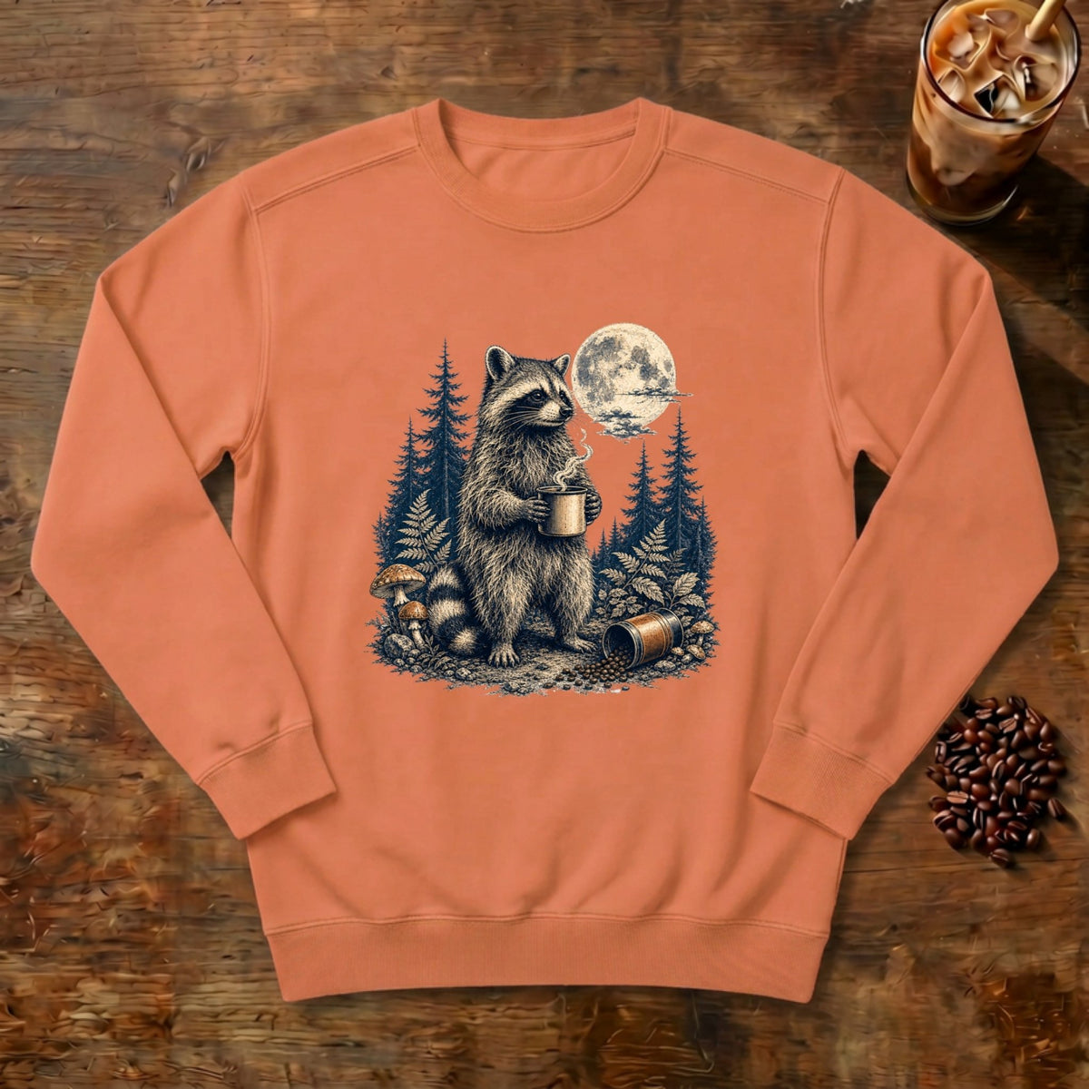Moonlit Raccoon Coffee Sweatshirt in Terracotta, a raccoon with coffee in a moonlit forest