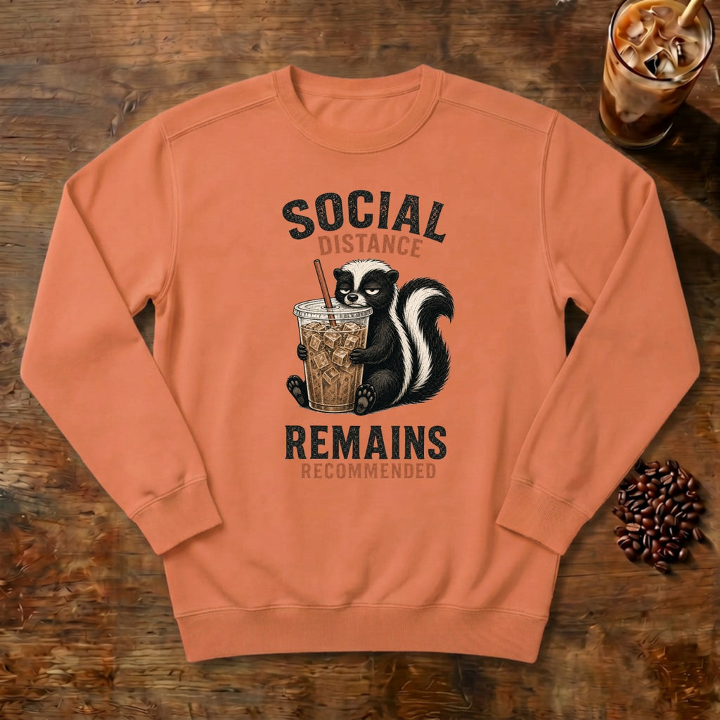 Social Distance Remains Skunk Sweatshirt in Terracotta, a retro skunk sipping iced coffee