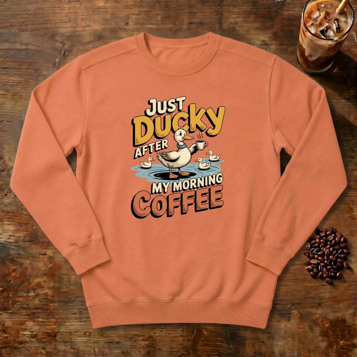 Just Ducky After My Morning Coffee Sweatshirt in Terracotta, a sleepy duck holding its coffee