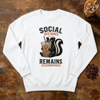 Social Distance Remains Skunk Sweatshirt in White, a retro skunk sipping iced coffee