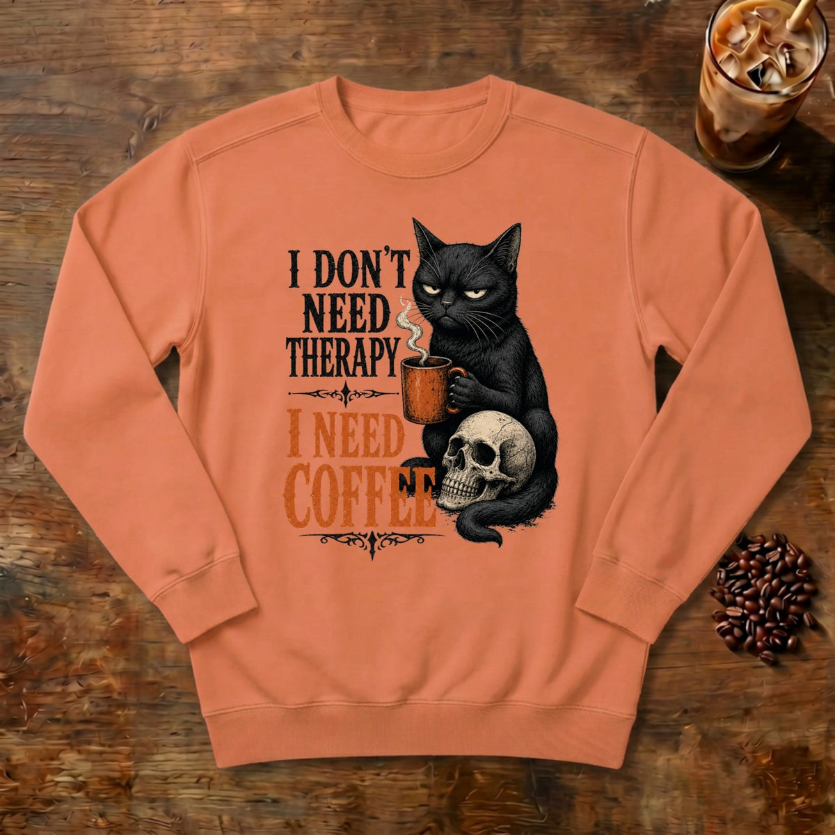 I Don't Need Therapy Cat Sweatshirt in Terracotta, a black cat holding a coffee mug and sitting on a skull