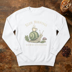Slow Mornings Snail Sweatshirt in White, a sleepy snail carrying a coffee cup on its shell