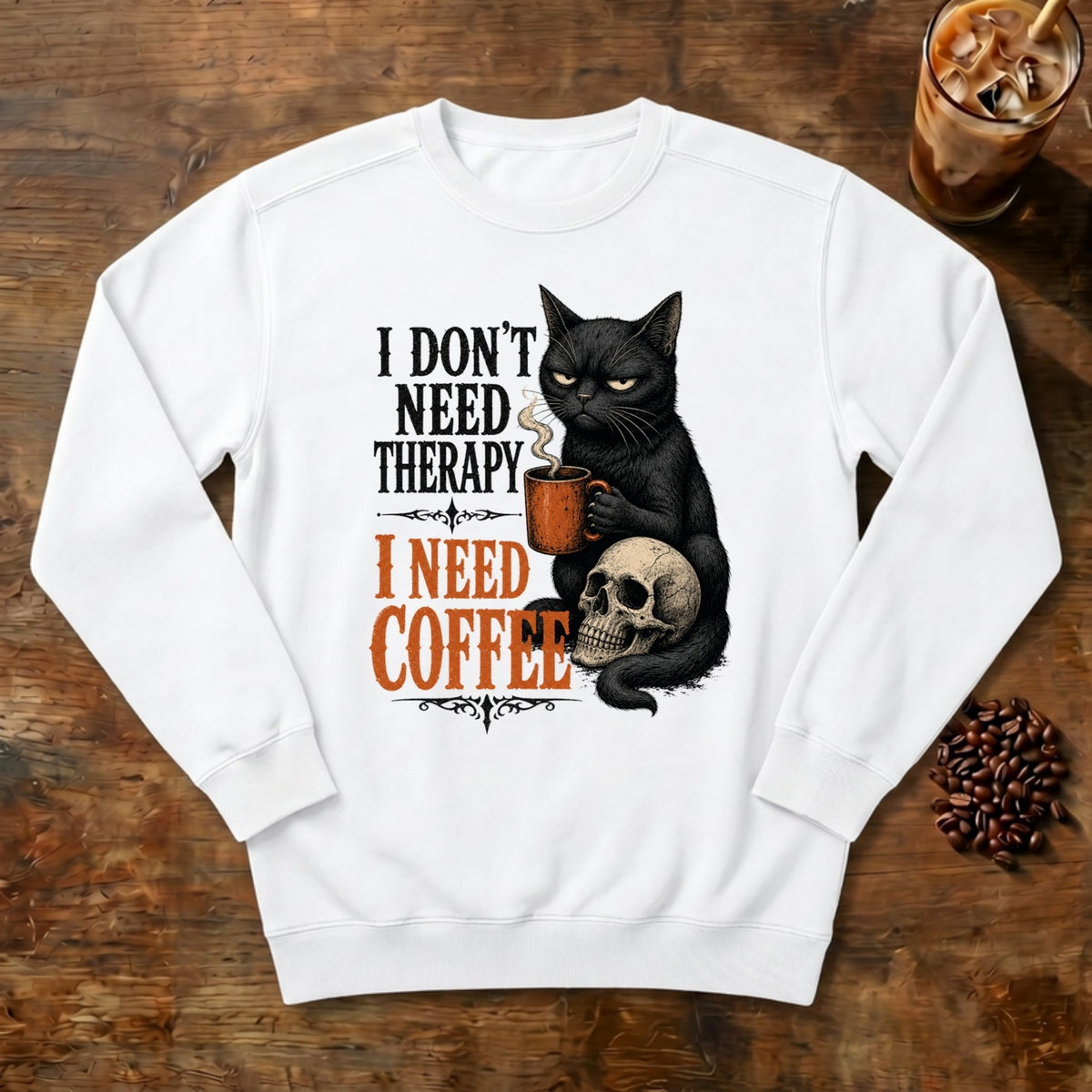 I Don't Need Therapy Cat Sweatshirt in White, a black cat holding a coffee mug and sitting on a skull