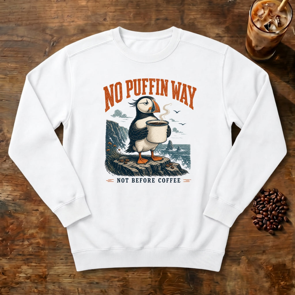 No Puffin Way Sweatshirt in White, a puffin holding a cup of coffee by the coast