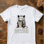 Wide-eyed opossum clutching an iced coffee with the words Playing Dead Was Never an Option on a White T-shirt.