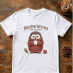 Small hedgehog in a chunky red knit sweater holding a mug with the words Sweater Weather. People Still Optional on a White T-shirt.