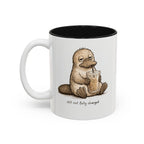 Still Not Fully Charged Platypus Coffee Mug, another view. Sleepy platypus sipping iced coffee with “still not fully charged” text