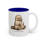Still Not Fully Charged Platypus Coffee Mug, white with blue interior. Sleepy platypus sipping iced coffee with “still not fully charged” text
