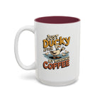 Just Ducky After My Morning Coffee Mug, 15 oz, white with maroon interior. Cheerful duck raising a coffee cup in a pond with ducklings and “Just Ducky After My Morning Coffee” text