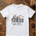 Exhausted opossum sprawled on its back playing dead on top of the words Playing Dead, reaching for a coffee cup, with Until Coffee below on a White T-shirt.