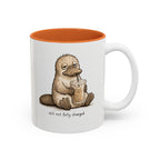 Still Not Fully Charged Platypus Coffee Mug, white with orange interior. Sleepy platypus sipping iced coffee with “still not fully charged” text