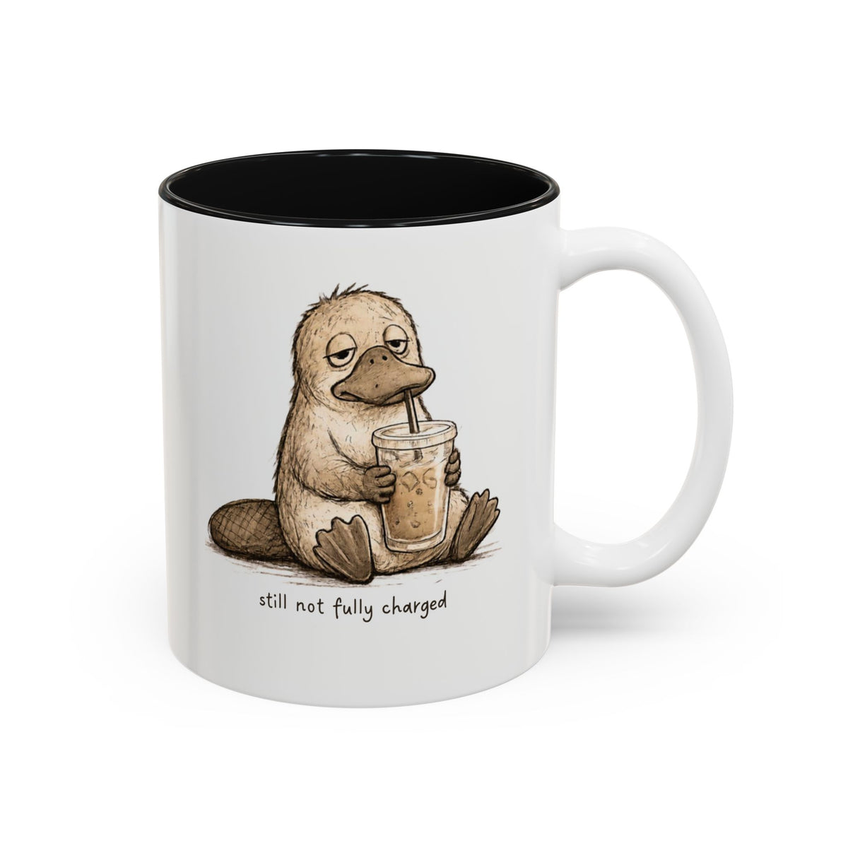 Still Not Fully Charged Platypus Coffee Mug, white with black interior. Sleepy platypus sipping iced coffee with “still not fully charged” text