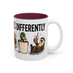 Everyone Copes Differently Animal Coffee Mug, another view. Wraparound mug with a raccoon, sloth, squirrel, duck and otter coping with coffee under “Everyone Copes Differently”