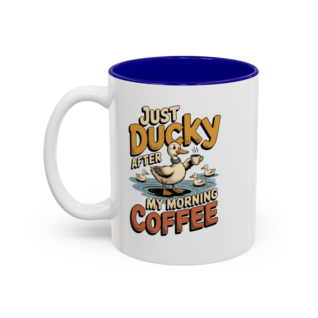 Just Ducky After My Morning Coffee Mug, 11 oz, white with blue interior. Cheerful duck raising a coffee cup in a pond with ducklings and “Just Ducky After My Morning Coffee” text