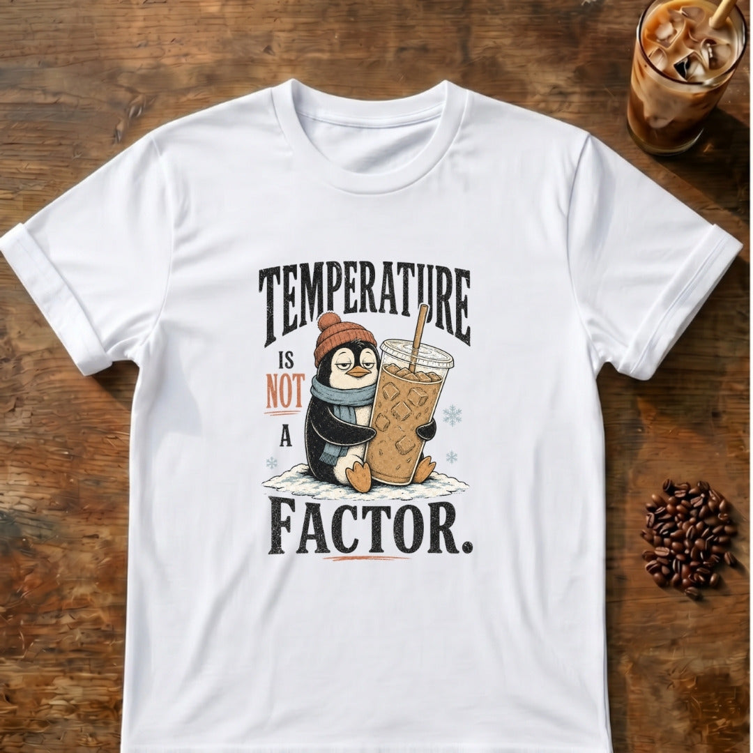 Penguin in a beanie and scarf hugging a giant iced coffee in the snow with the words Temperature Is Not a Factor on a White T-shirt.