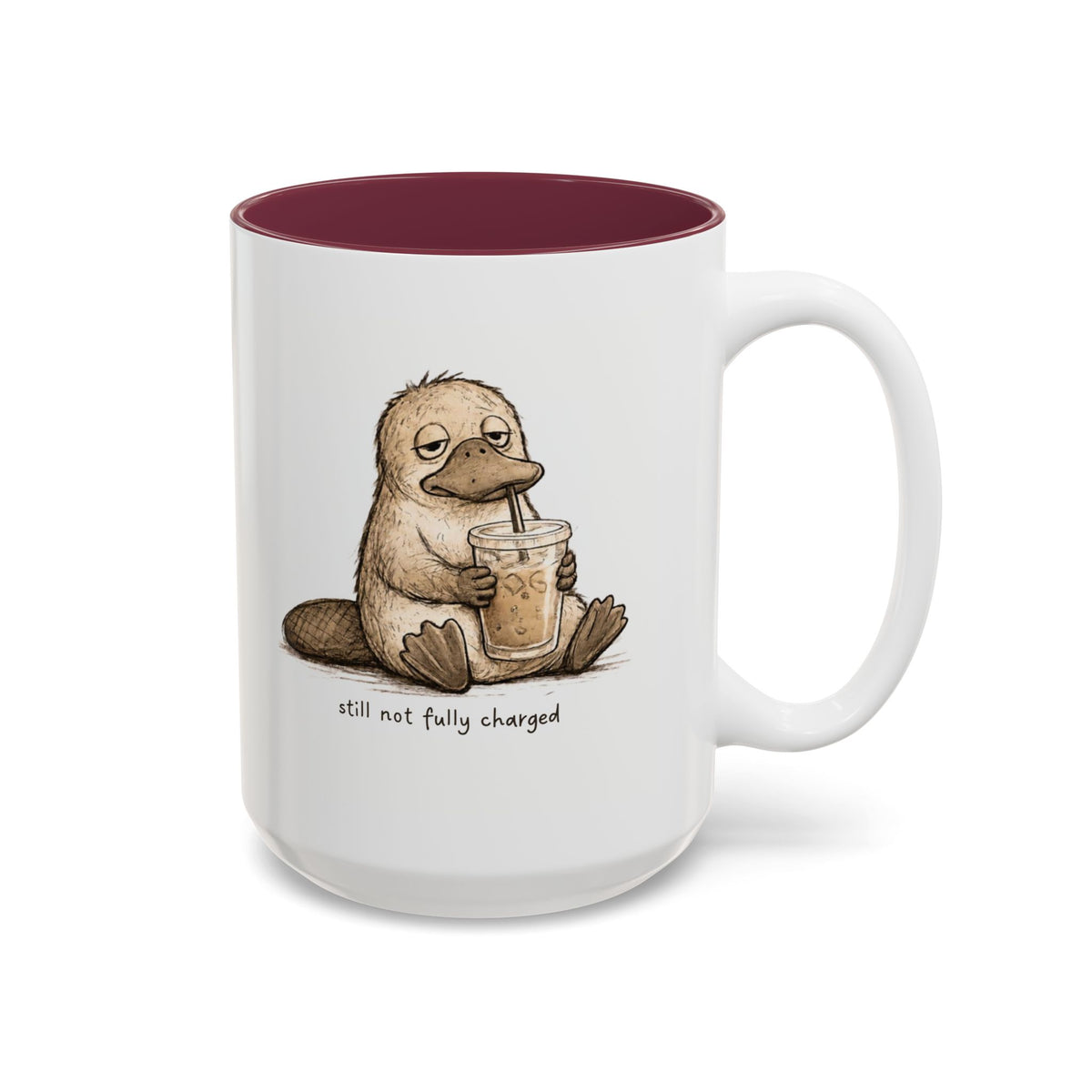 Still Not Fully Charged Platypus Coffee Mug, another view. Sleepy platypus sipping iced coffee with “still not fully charged” text