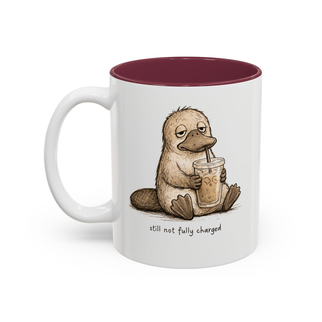 Still Not Fully Charged Platypus Coffee Mug, another view. Sleepy platypus sipping iced coffee with “still not fully charged” text