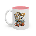Just Ducky After My Morning Coffee Mug, 11 oz, white with pink interior. Cheerful duck raising a coffee cup in a pond with ducklings and “Just Ducky After My Morning Coffee” text