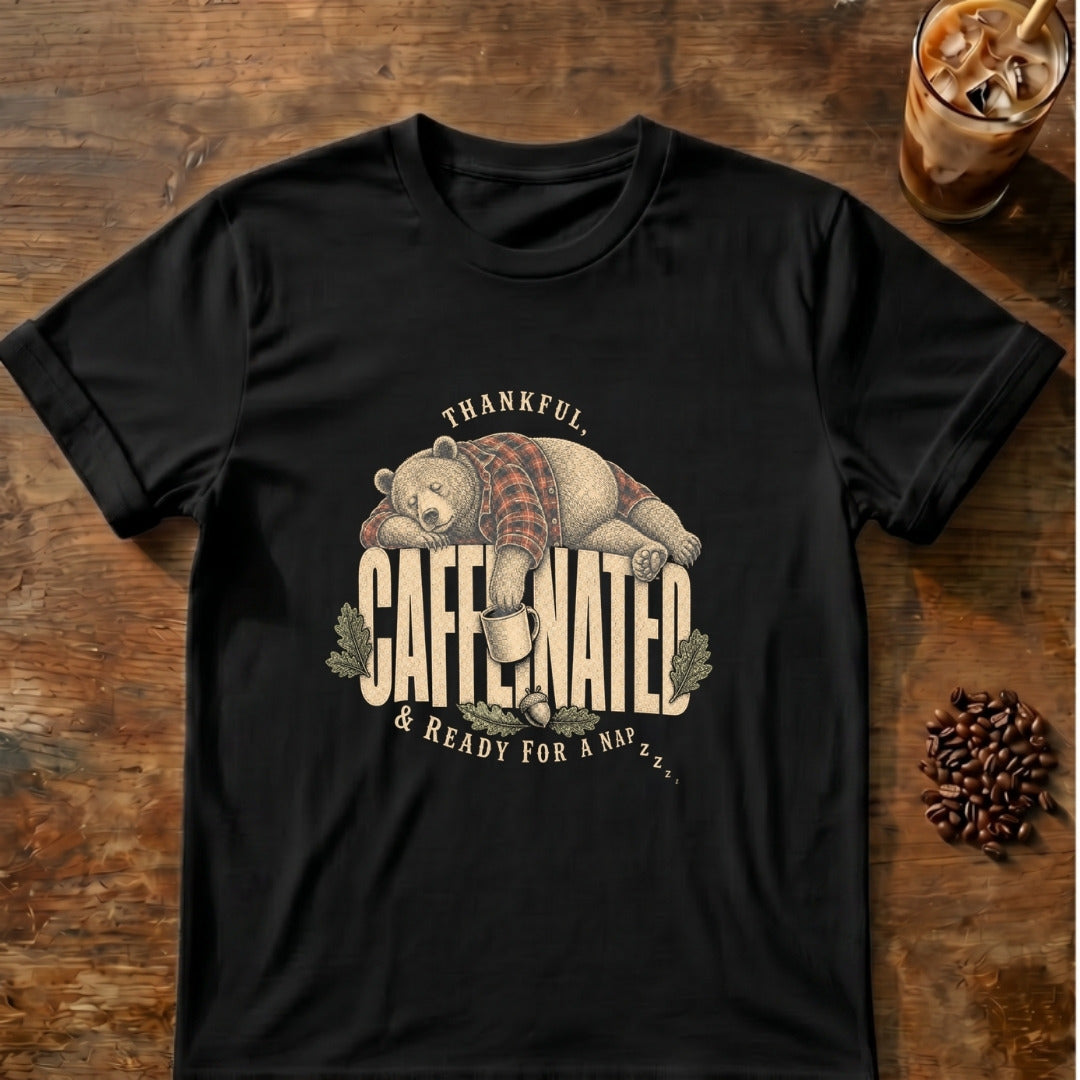 Sleepy bear in a plaid flannel shirt napping on top of the word Caffeinated with a mug in hand and the words Thankful and Ready for a Nap on a Black T-shirt.