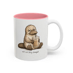 Still Not Fully Charged Platypus Coffee Mug, white with pink interior. Sleepy platypus sipping iced coffee with “still not fully charged” text