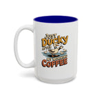 Just Ducky After My Morning Coffee Mug, 15 oz, white with blue interior. Cheerful duck raising a coffee cup in a pond with ducklings and “Just Ducky After My Morning Coffee” text