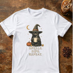 Black cat in a witch hat holding a steaming mug beside a pumpkin under a crescent moon with the words Spells. Sips. Repeat on a White T-shirt.