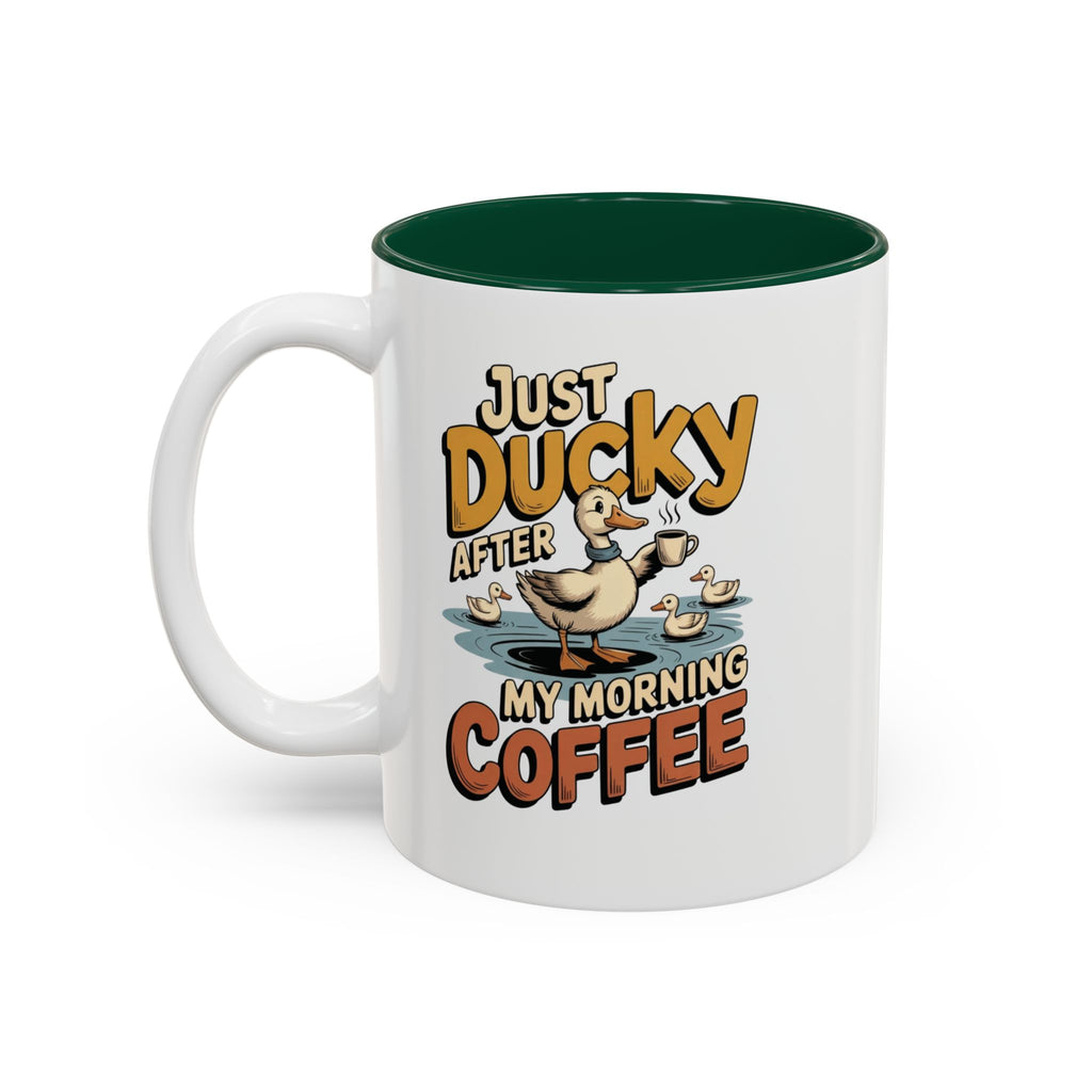 Just Ducky After My Morning Coffee Mug, 11 oz, white with green interior. Cheerful duck raising a coffee cup in a pond with ducklings and “Just Ducky After My Morning Coffee” text