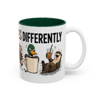 Everyone Copes Differently Animal Coffee Mug, another view. Wraparound mug with a raccoon, sloth, squirrel, duck and otter coping with coffee under “Everyone Copes Differently”