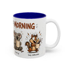 Stages of Morning Animal Coffee Mug, another view. Wraparound mug of cute animals, including a koala and a skunk, going through the “Stages of Morning” with coffee