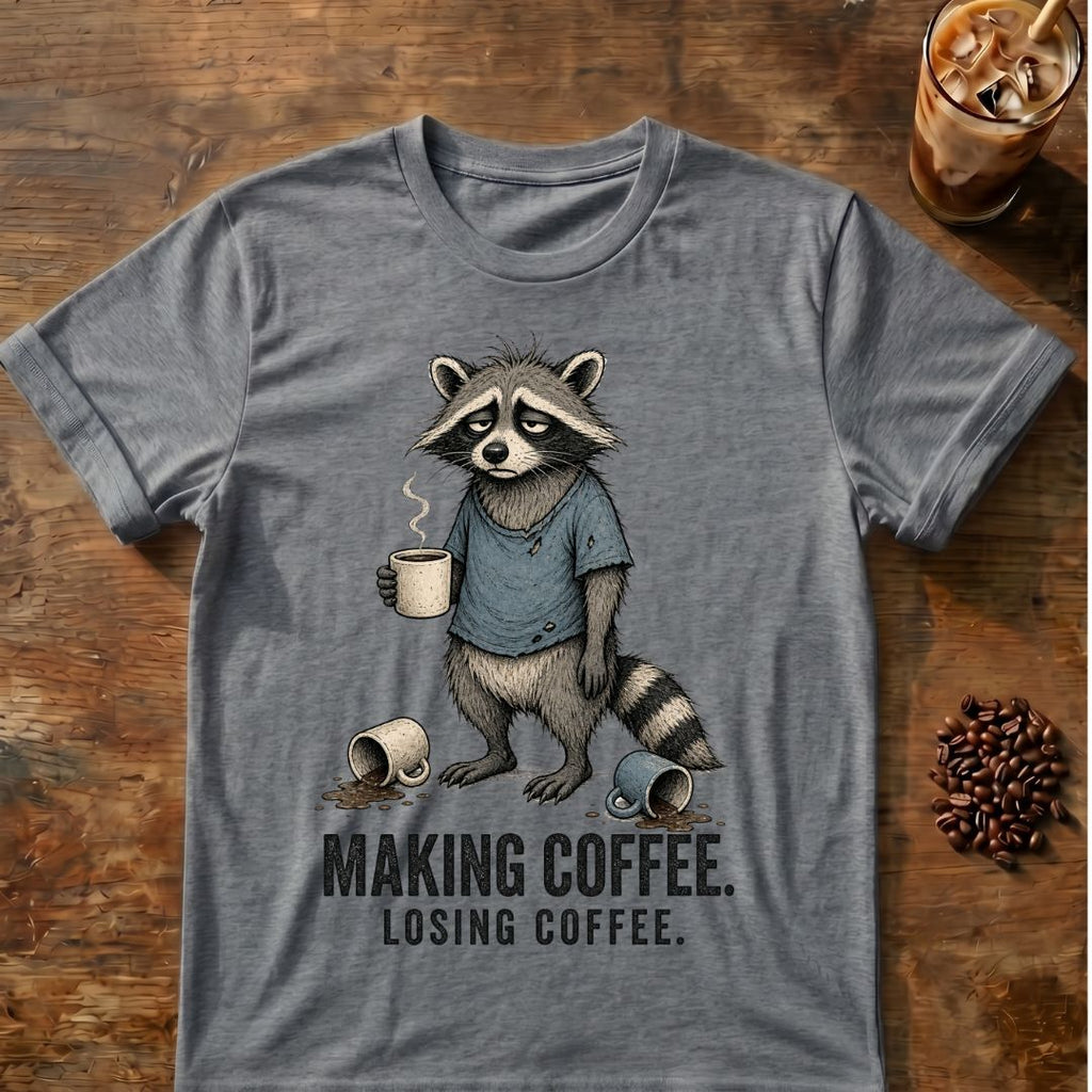 Raccoon coffee graphic on a Graphite Heather T-shirt