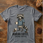 Raccoon coffee graphic on a Graphite Heather T-shirt