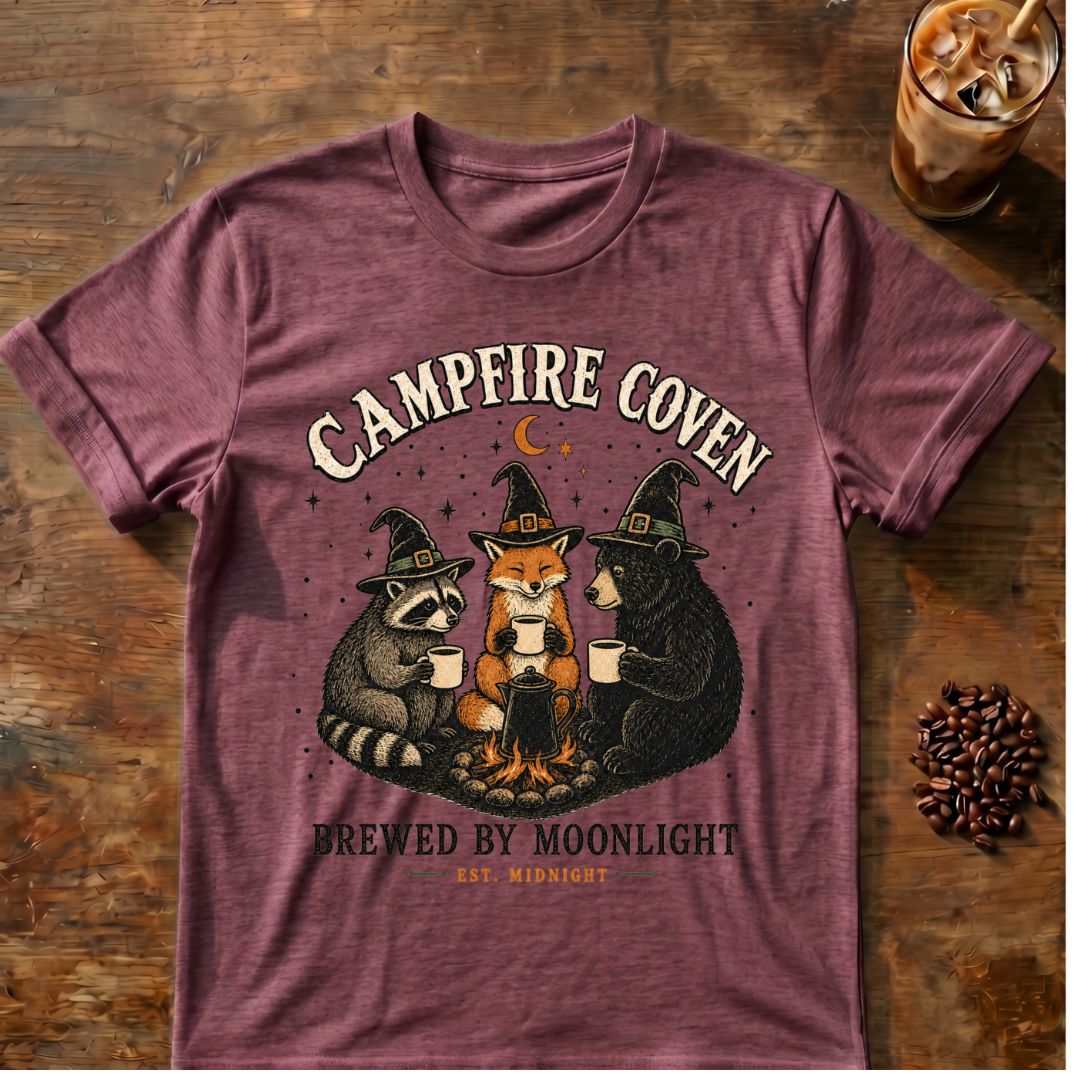 Raccoon coffee graphic for Campfire Coven Coffee on heather-maroon T-shirt