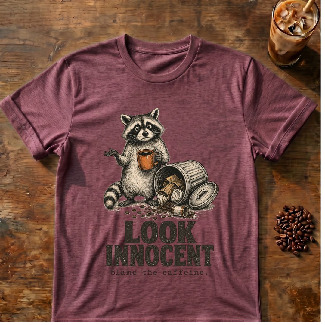 Raccoon coffee graphic for Look Innocent Raccoon on heather-maroon T-shirt
