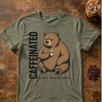 Caffeinated bear coffee graphic on a Heather Military Green T-shirt