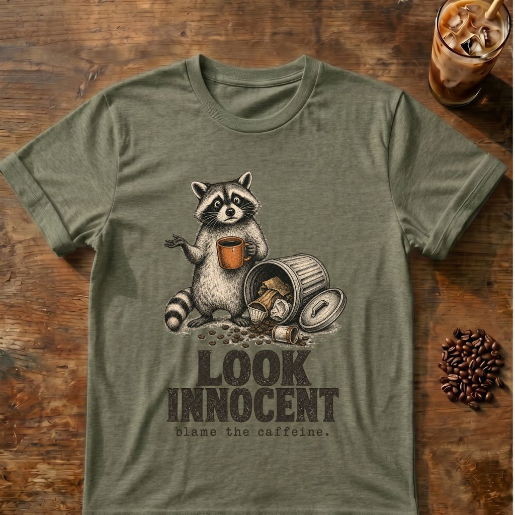 Raccoon coffee graphic for Look Innocent Raccoon on heather-military-green T-shirt